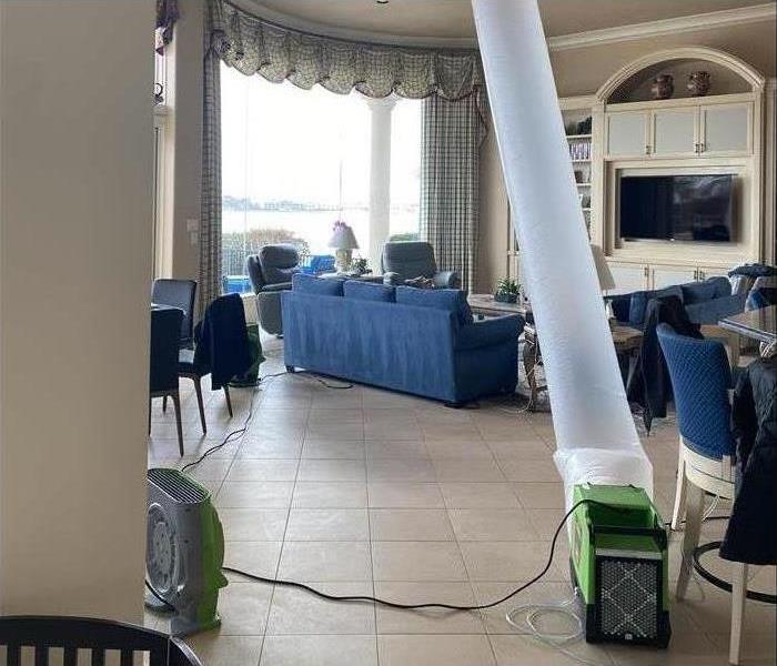 Fans and blowers being used to dry out a living room