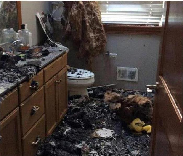lots of debris in a burned out bathroom